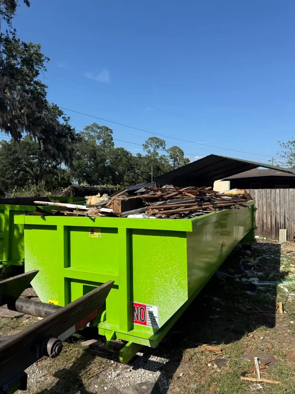 Madd Dumpsters roll off container loaded with roofing tear off debris